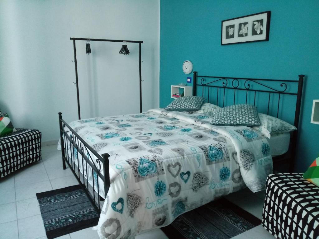 ein Schlafzimmer mit einem Bett mit einer Bettdecke darauf in der Unterkunft San Nicola Apartment Blu in Neapel