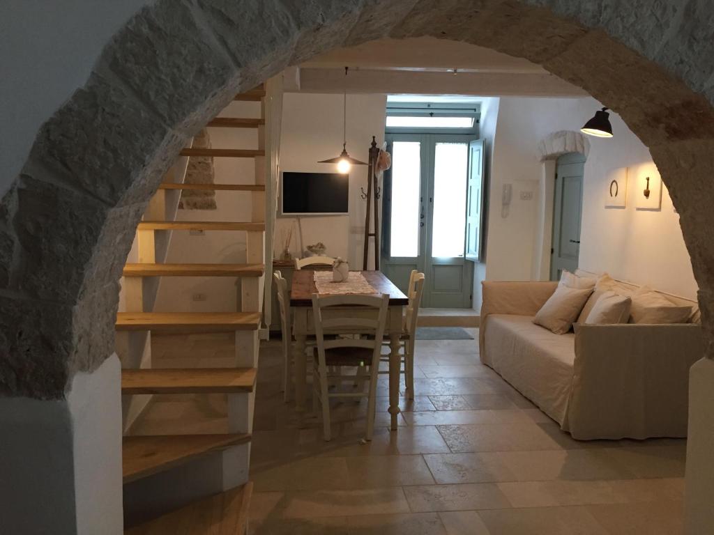 a living room filled with furniture and a staircase at Trullo Essenza-Trulli Antì Charme & Relax in Alberobello