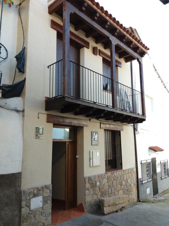 a building with a balcony on the side of it at La Casa de Mi Abuela in Aldeanueva del Camino