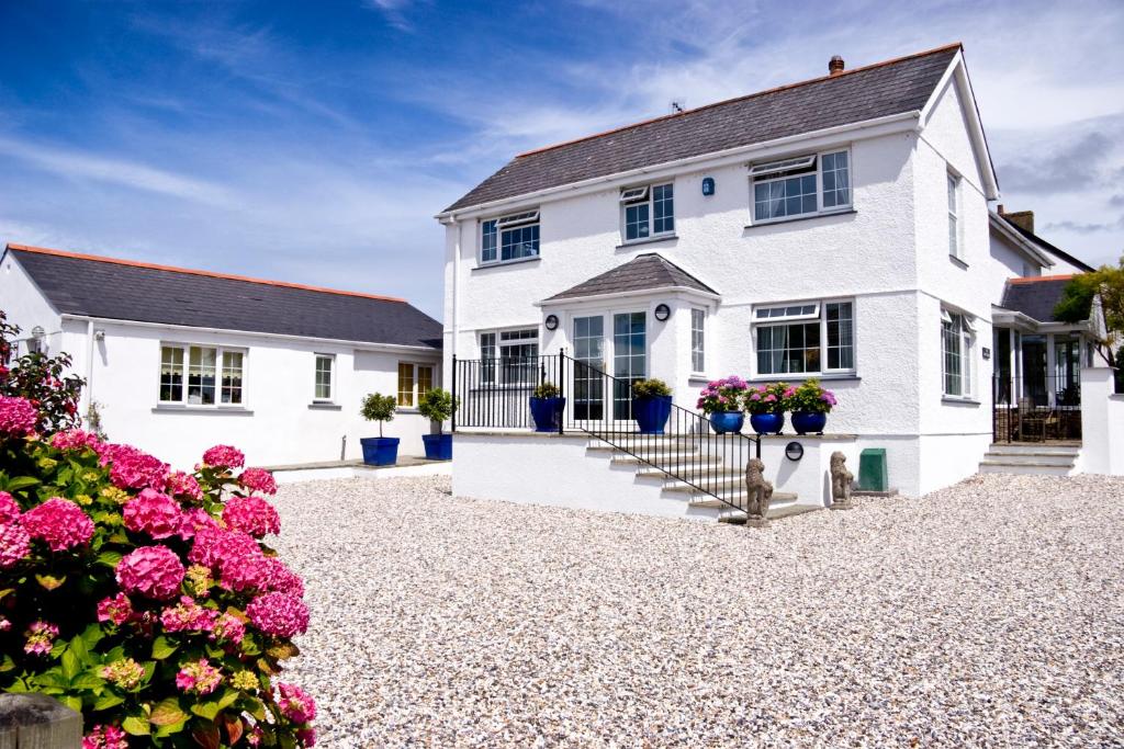 a white house with flowers in front of it at The White House in Padstow