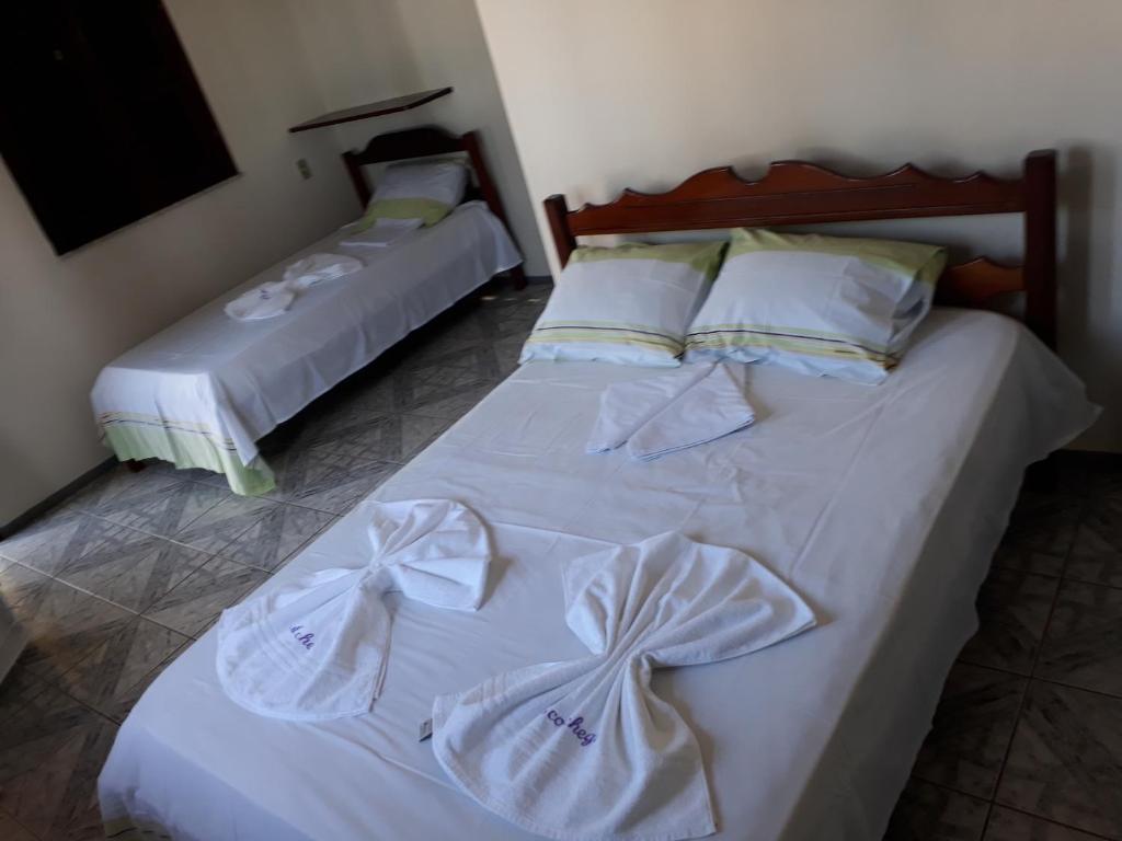 En eller flere senger på et rom på Pousada Aconchego