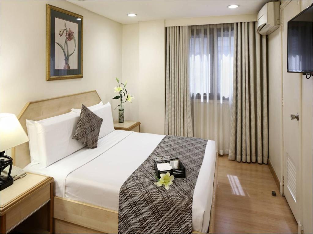 Postel nebo postele na pokoji v ubytování Manila Lotus Hotel