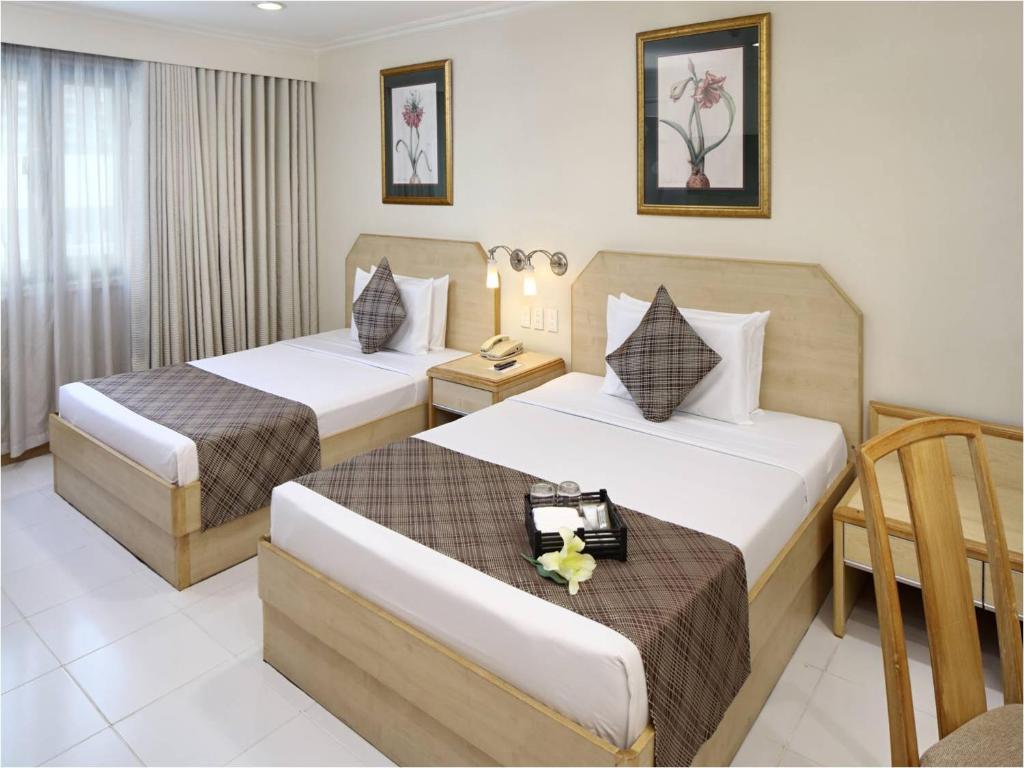 Postel nebo postele na pokoji v ubytování Manila Lotus Hotel