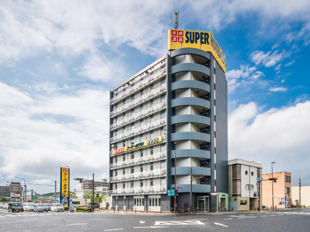 a building with a sign on the top of it at Super Hotel Tottori Station North Exit Smoke-Free in Tottori