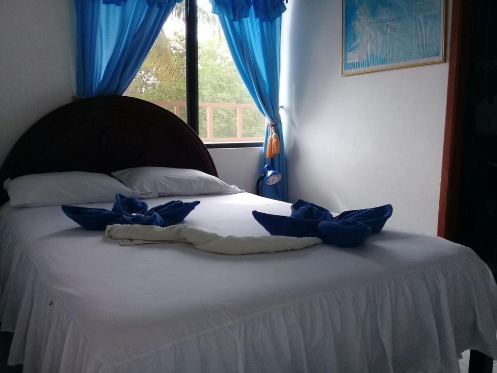 Postel nebo postele na pokoji v ubytování Hostal Insular