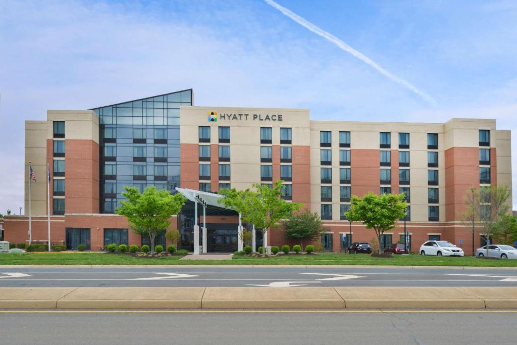 a large building with a large clock on it at Hyatt Place Herndon Dulles Airport East in Herndon
