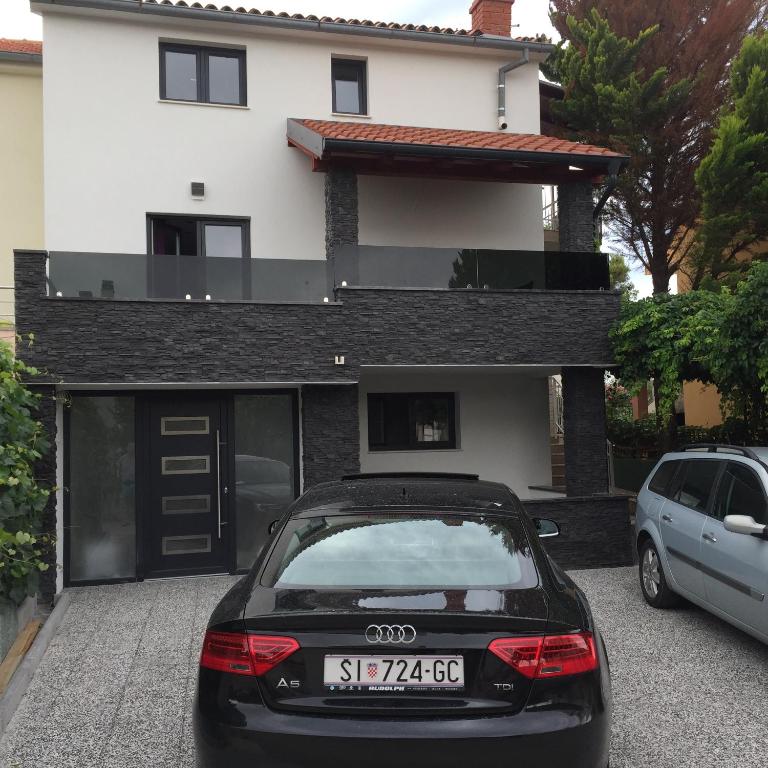 Ein schwarzes Auto parkte vor einem Haus in der Unterkunft Vila Nera in Zaboric