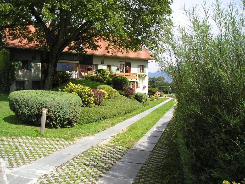 a house with a walkway in front of a yard at Le Charmagit in La Roche-sur-Foron