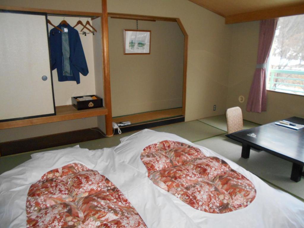 Postel nebo postele na pokoji v ubytování Hotel Yunojin