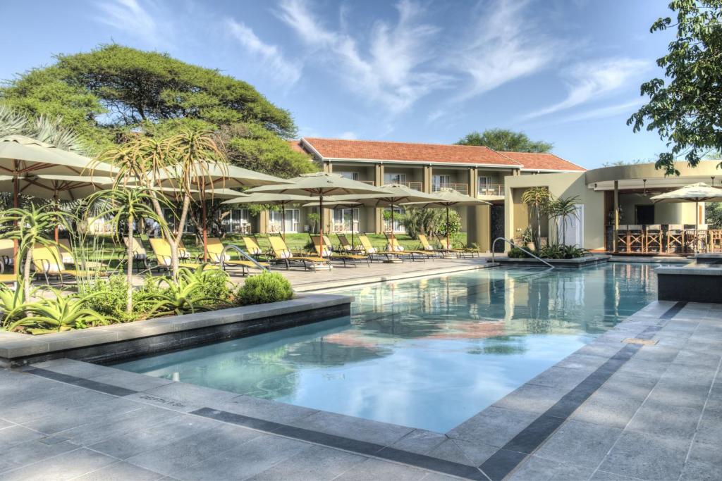 an image of a swimming pool at a resort at Ghost Mountain Inn in Mkuze