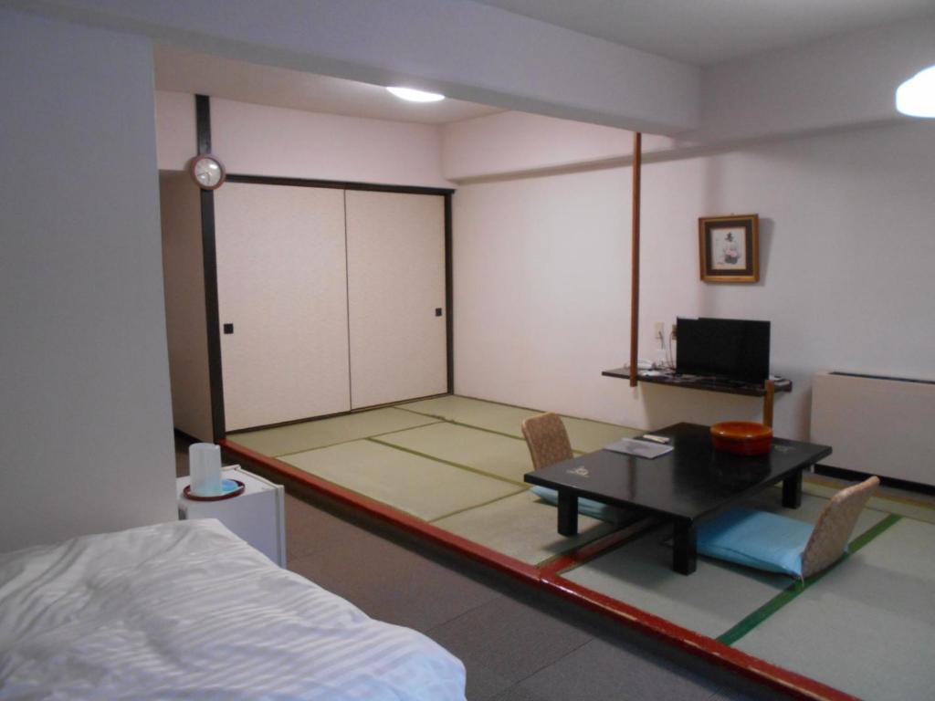 Postel nebo postele na pokoji v ubytování Hotel Yunojin