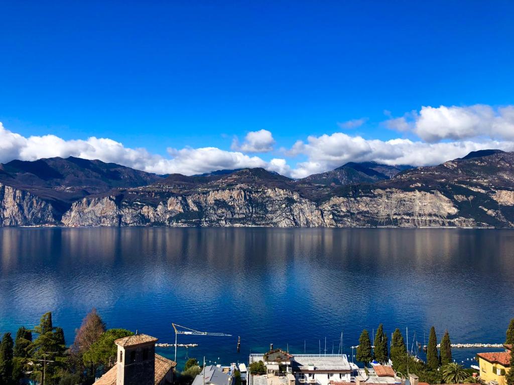 a view of a large body of water with mountains at Villa Emma Malcesine in Malcesine