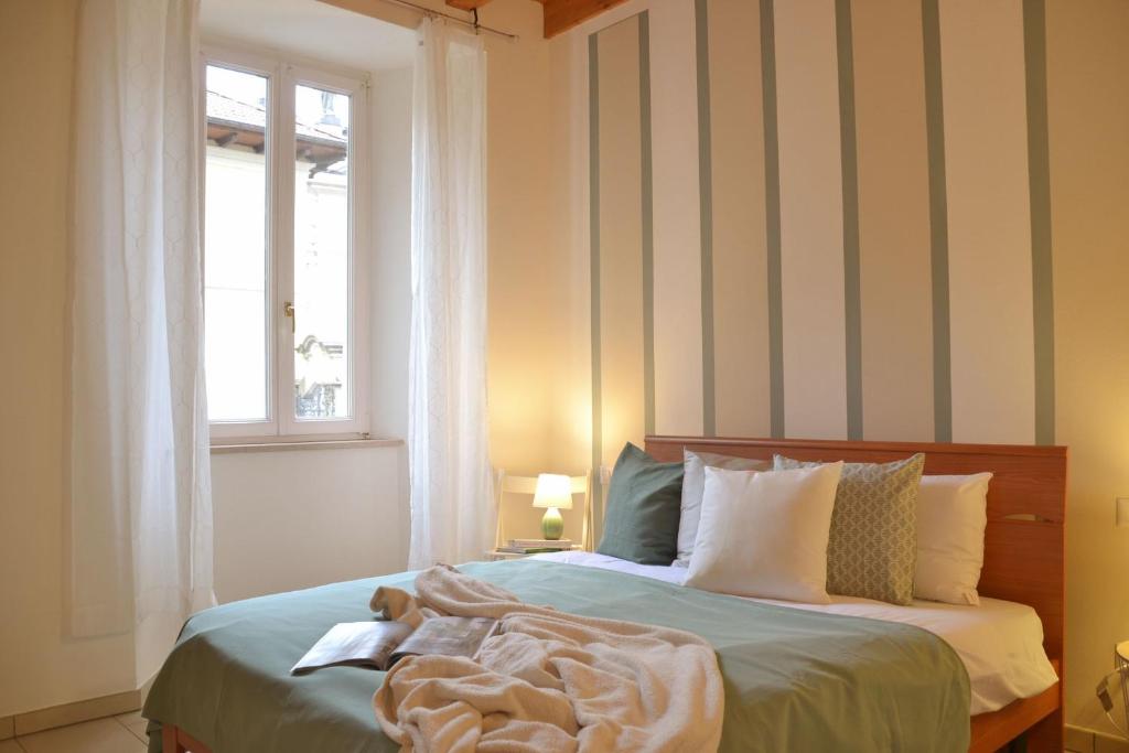 a bedroom with a bed with a blanket on it at Casa Josa - WelcHome in Cannobio
