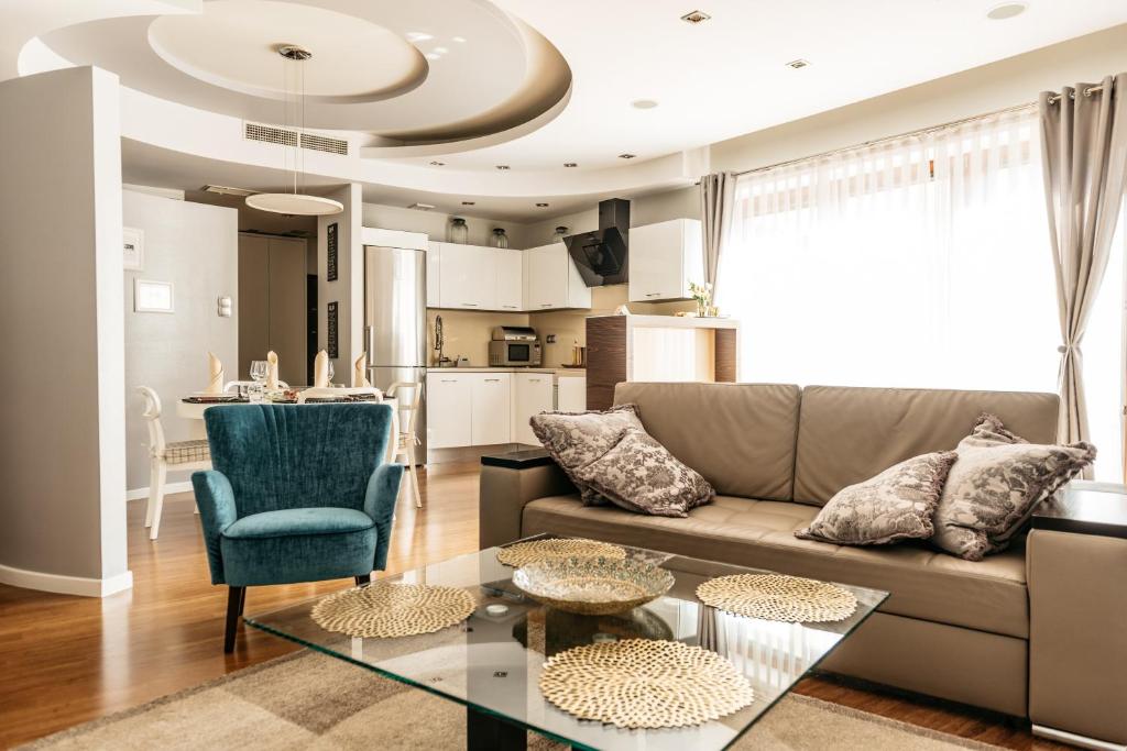 a living room with a couch and a table at Piedmont Apartments by LoftAffair in Krakow