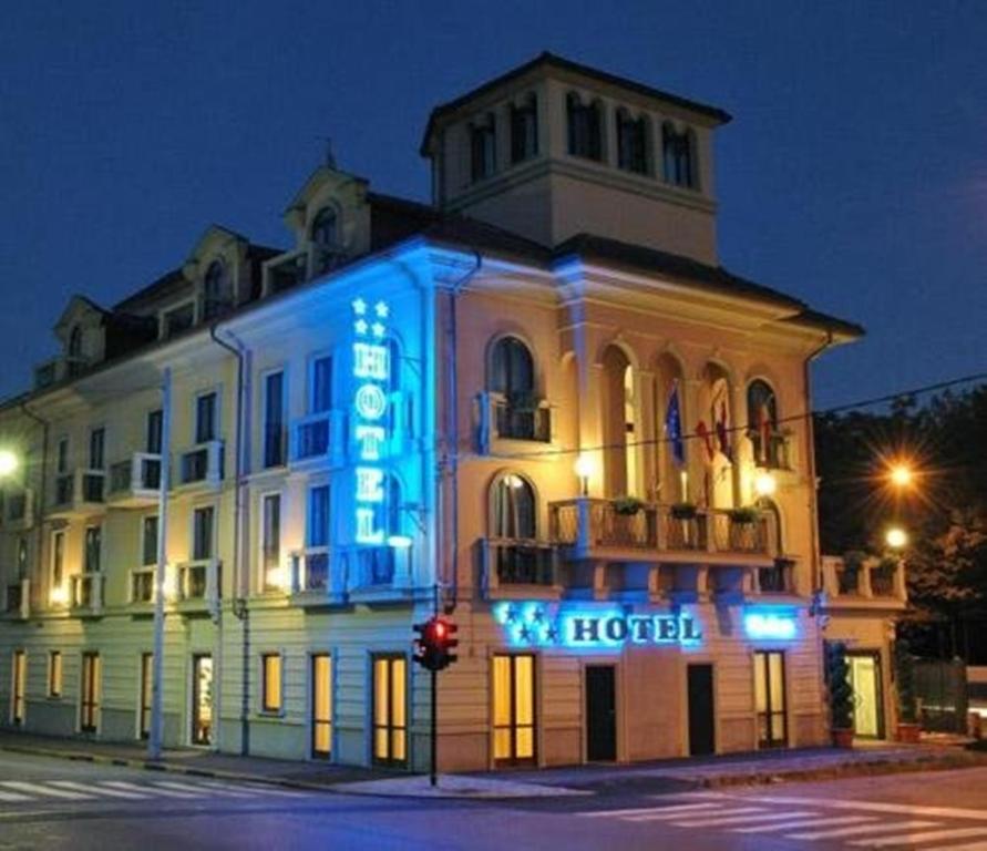 a building with a hotel sign in front of it at Hotel Villa Savoia in Turin