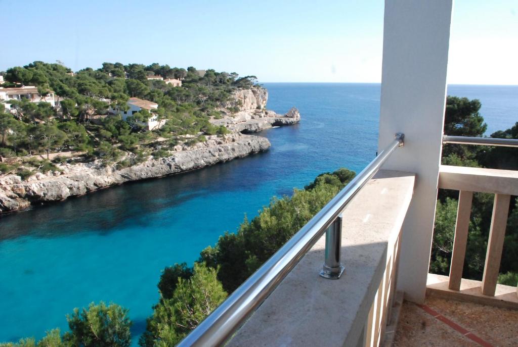 a view of the ocean from a balcony at Hotel Pinos Playa in Cala Santanyi