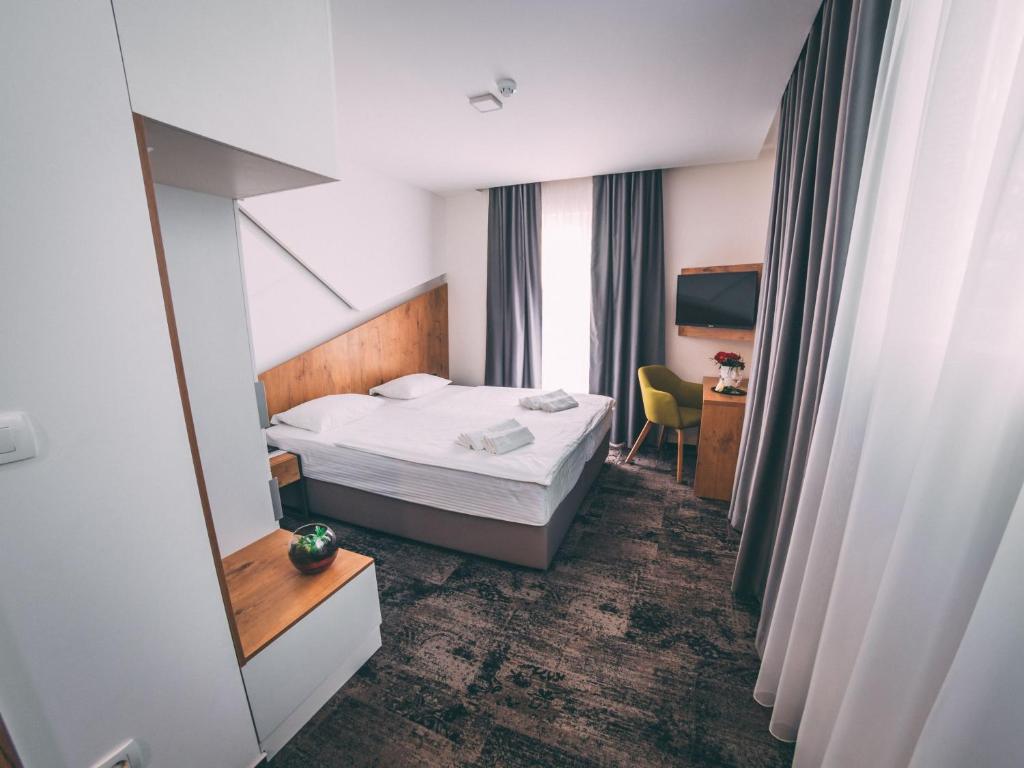 Postel nebo postele na pokoji v ubytování Orange Hotel