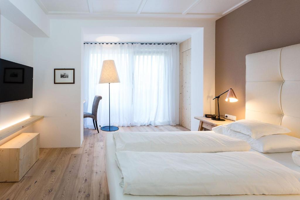 Postel nebo postele na pokoji v ubytování Hotel MAYR