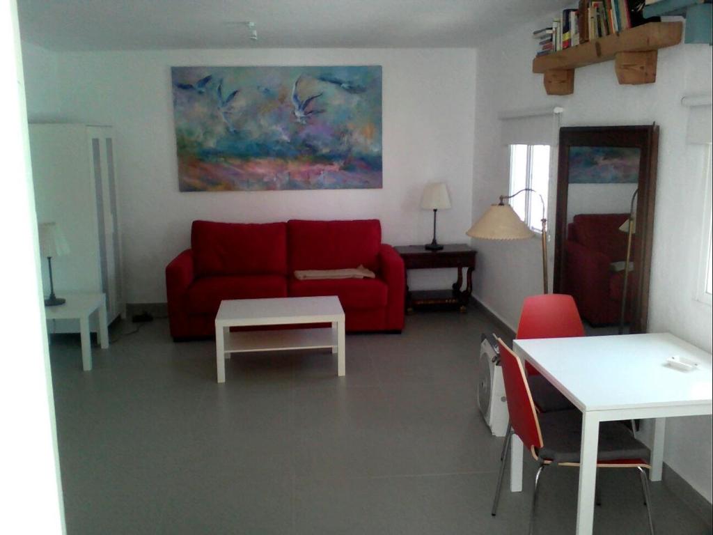 ベヘール・デ・ラ・フロンテーラにあるLa Fuenteのリビングルーム(赤いソファ、テーブル付)