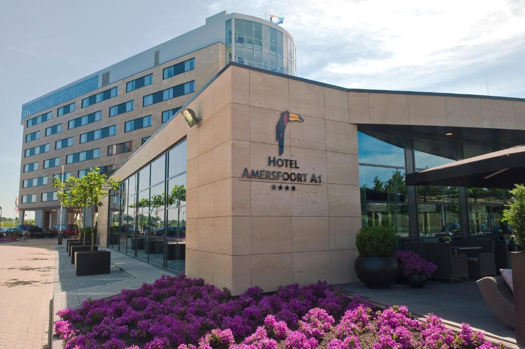 
a large building with a clock on the front of it at Van der Valk Hotel Amersfoort A1 in Amersfoort
