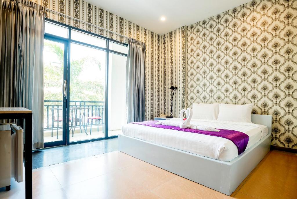 Postel nebo postele na pokoji v ubytování White Residence Hotel & Apartment