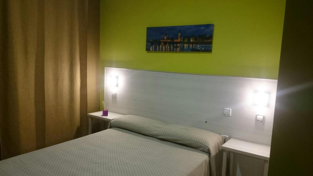 Postel nebo postele na pokoji v ubytování Hostal DS