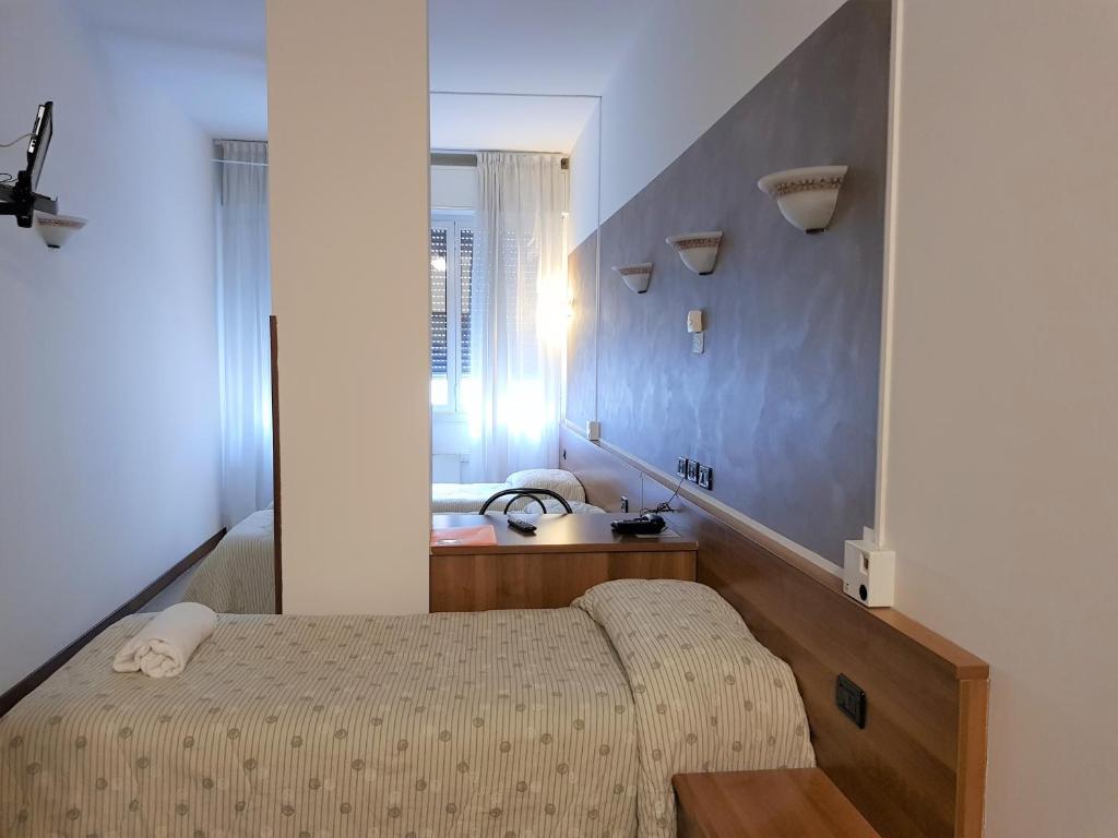 Postel nebo postele na pokoji v ubytování Hotel Marinoni