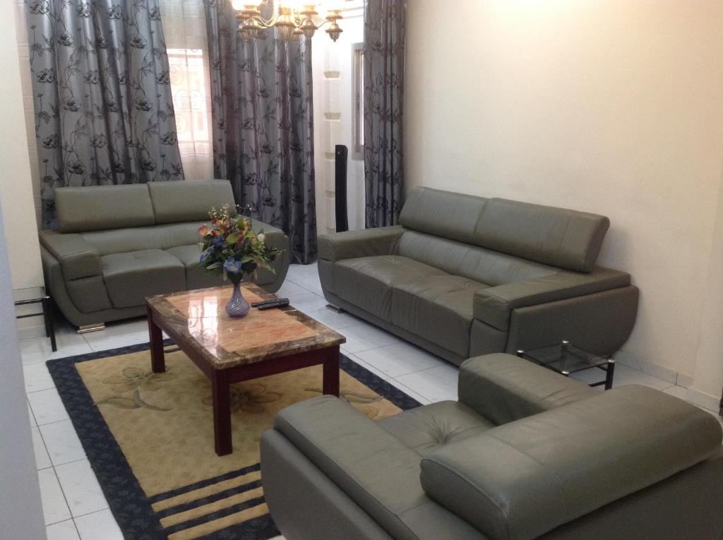 a living room with couches and a coffee table at Bastos'Appart YAOUNDE in Yaoundé