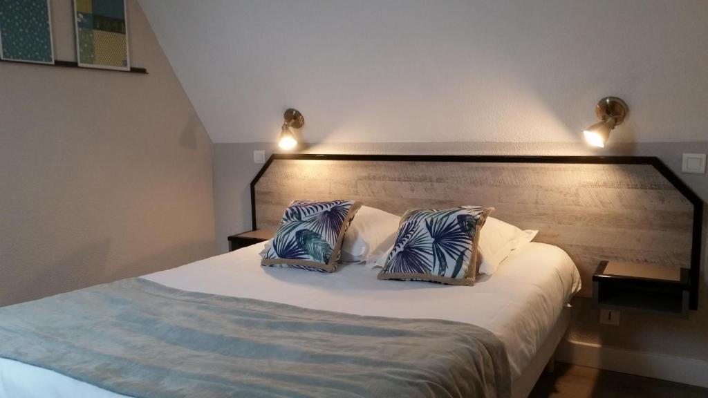 Llit o llits en una habitació de Amadour Hôtel