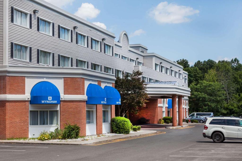 a hotel with a car parked in front of it at Wyndham Southbury in Southbury