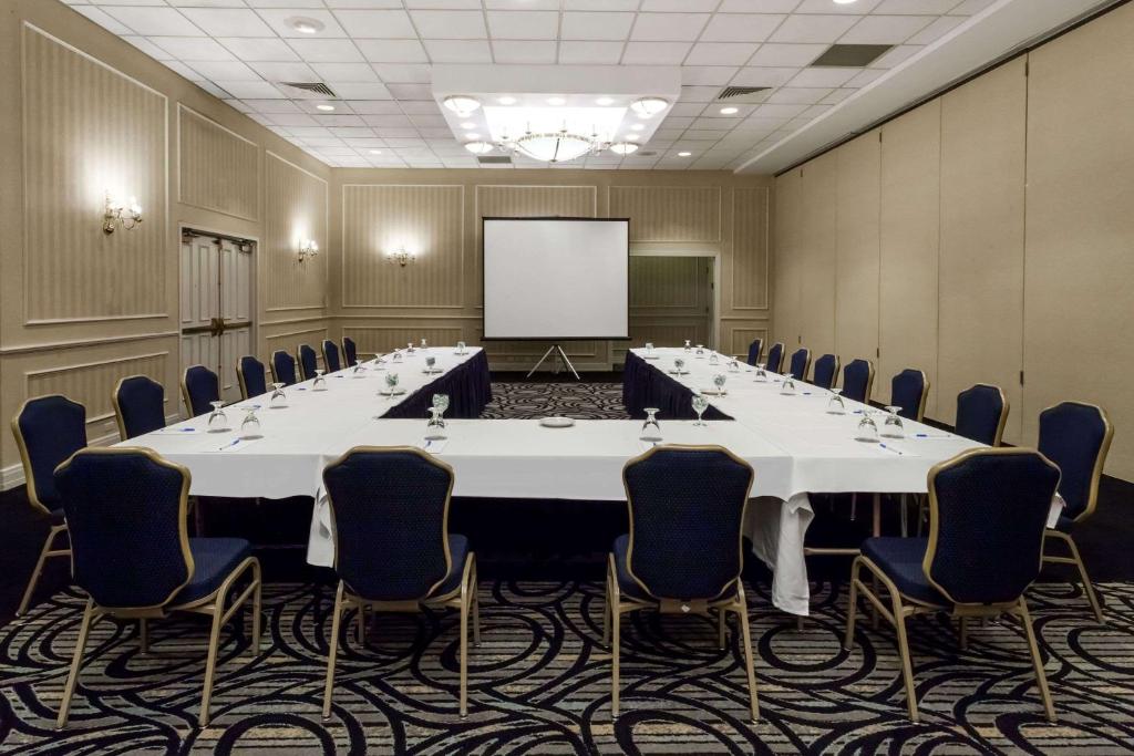 a conference room with a large table and chairs at Wyndham Southbury in Southbury