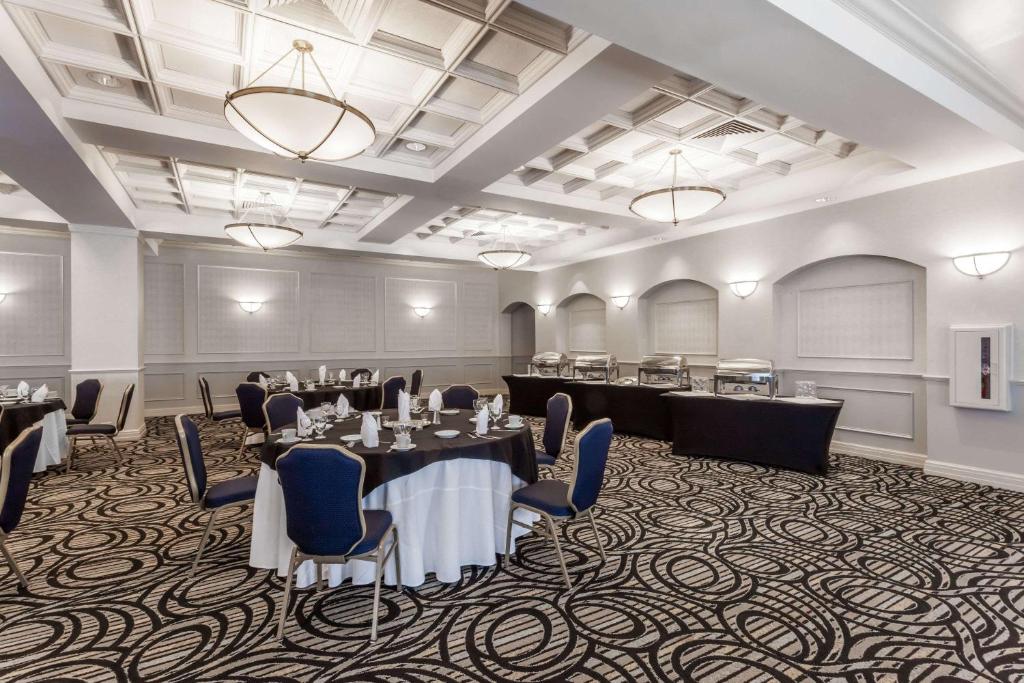 a conference room with tables and chairs and a podium at Wyndham Southbury in Southbury