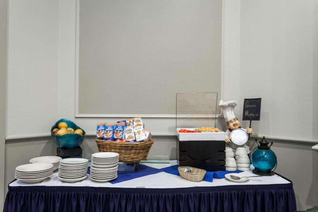 a table with plates and a basket of food on it at Wyndham Southbury in Southbury