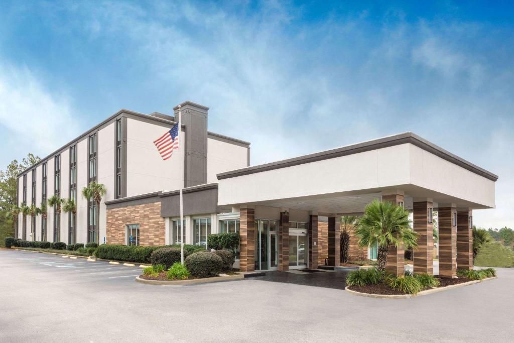 an office building with an american flag on it at Wyndham Garden Summerville in Summerville
