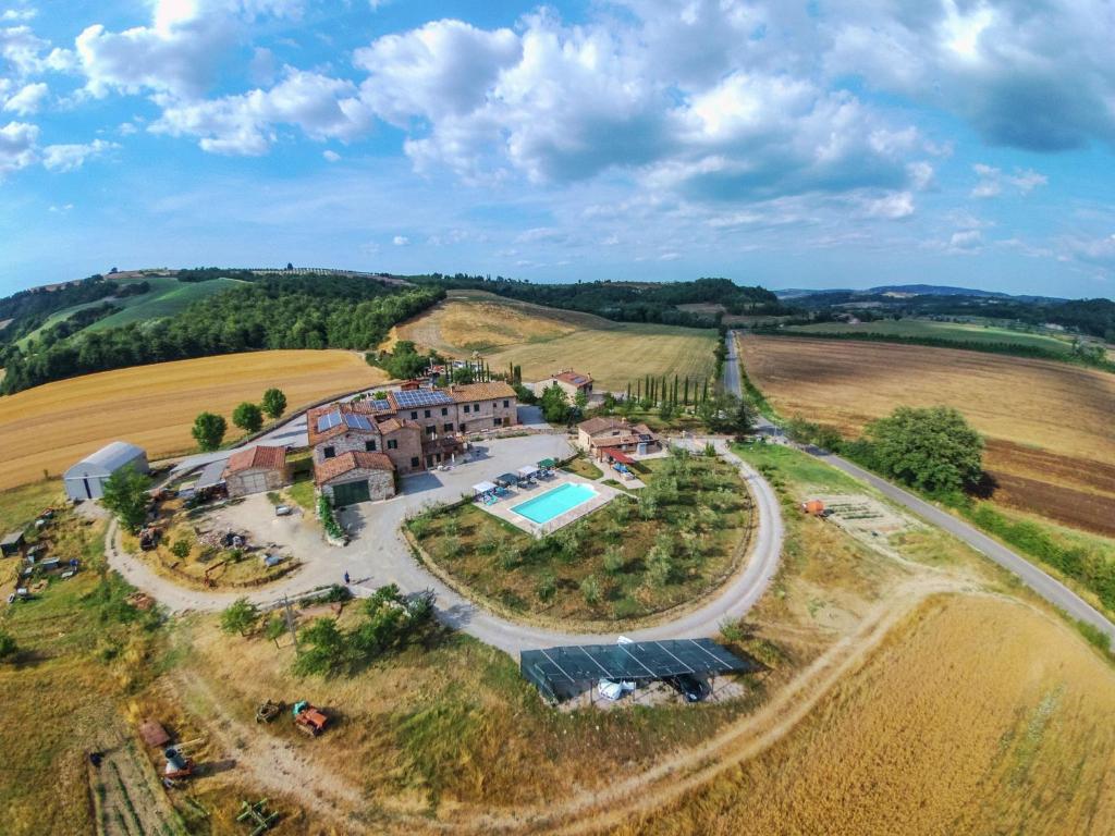 an aerial view of a house in the middle of a field at Gorgeous Cottage in Asciano with Swimming Pool in Asciano
