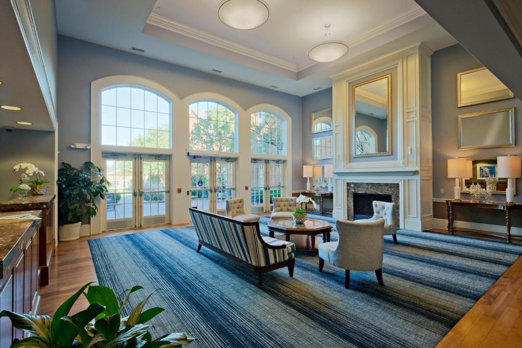 a living room with a fireplace and a table and chairs at Nationwide Hotel and Conference Center in Lewis Center