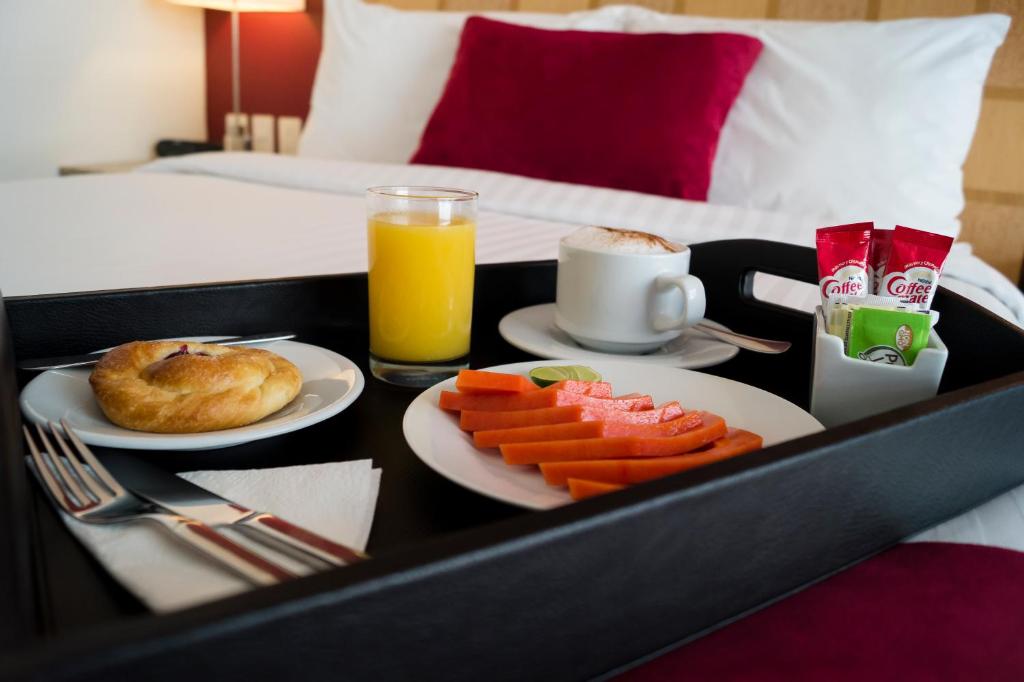 A tray-service breakfast arranged on a bed.
