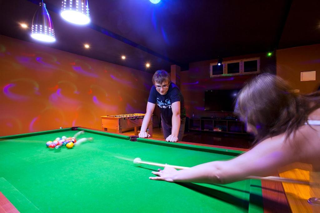 a young boy playing pool in a pool table at Kaani Beach Hotel in Maafushi