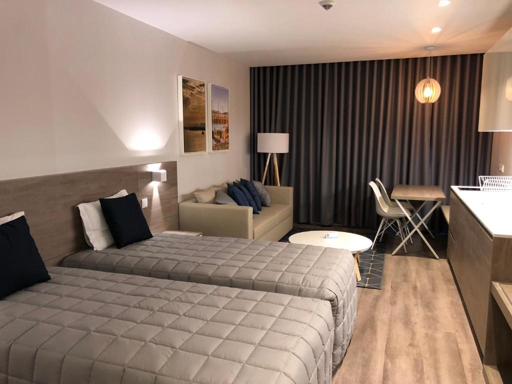 Hotel do Parque tesisinde bir odada yatak veya yataklar