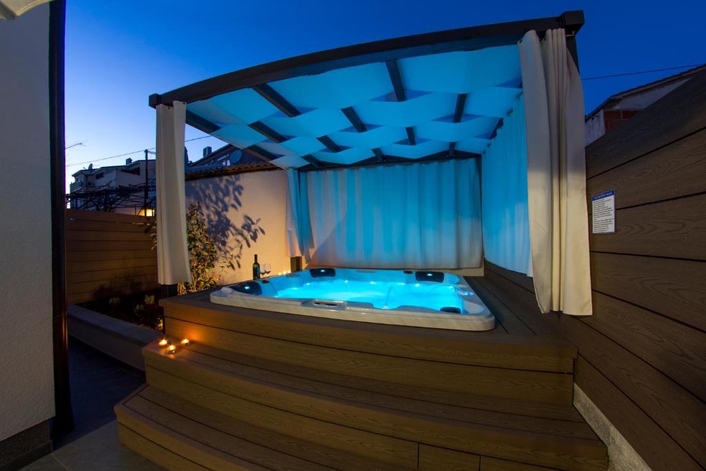 a jacuzzi tub sitting on a deck with avisor at Apartment L Rovinj with Private Jacuzzi in Rovinj