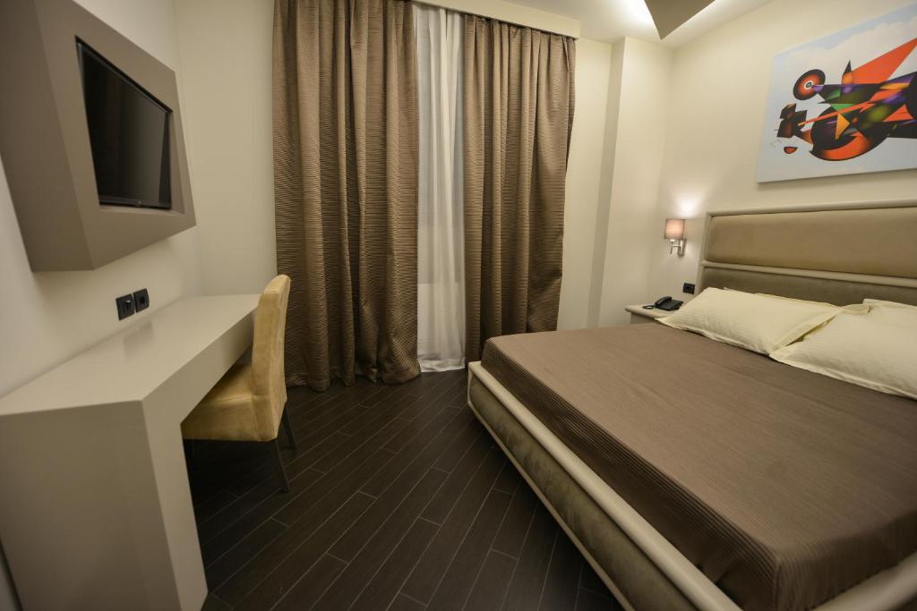 Uma cama ou camas num quarto em Petit Hotel Elita
