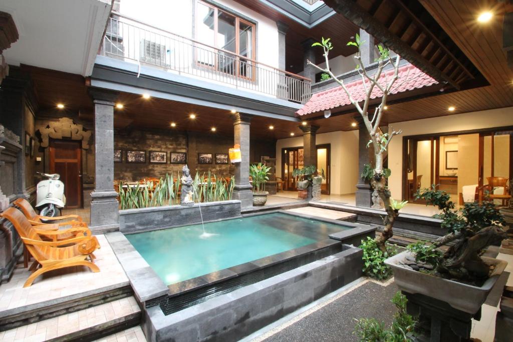 a swimming pool in the middle of a house at Yuni's House in Ubud