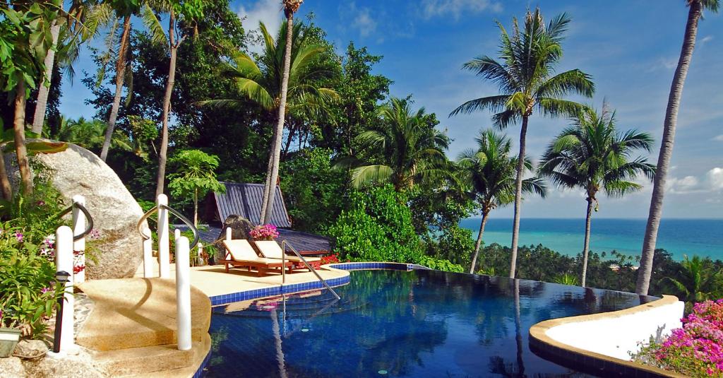 a resort swimming pool with a view of the ocean at Seaview Paradise Mountain Holiday Villas Resort in Lamai