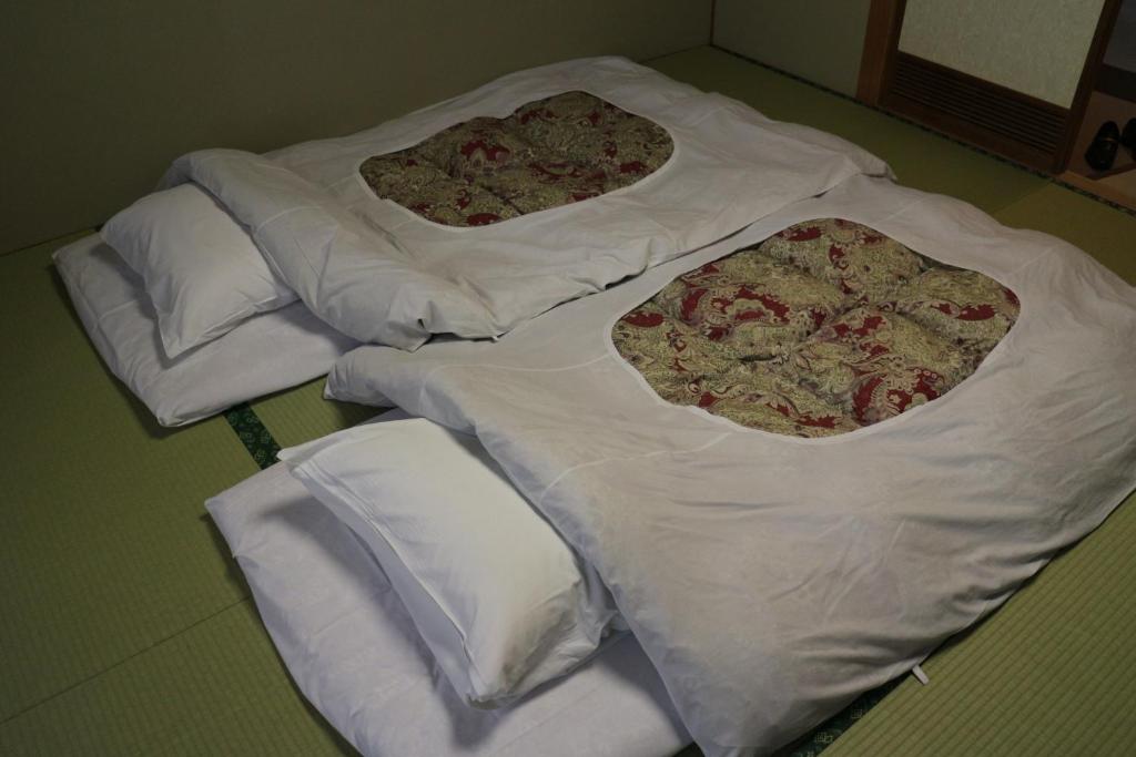 Postel nebo postele na pokoji v ubytování Hotel New Kotobuki