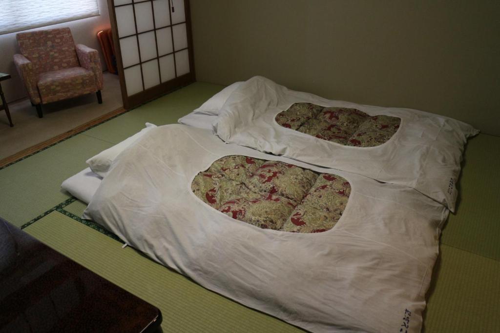 Postel nebo postele na pokoji v ubytování Hotel New Kotobuki