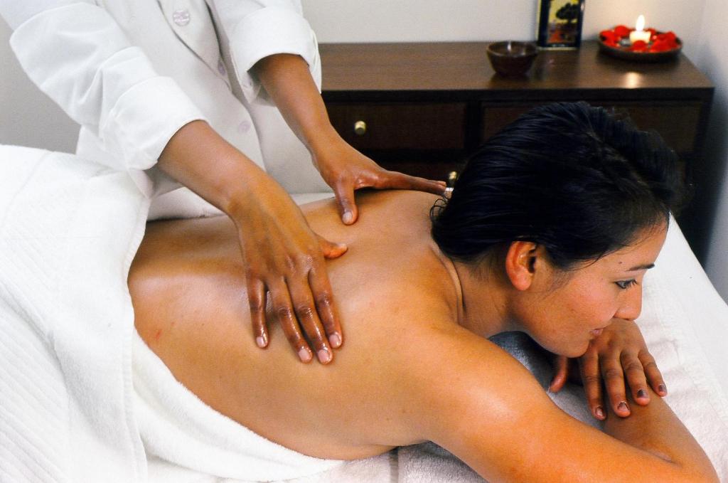 a woman getting a massage from a therapist at Namah Nainital, a member of Radisson Individuals Retreats in Nainital