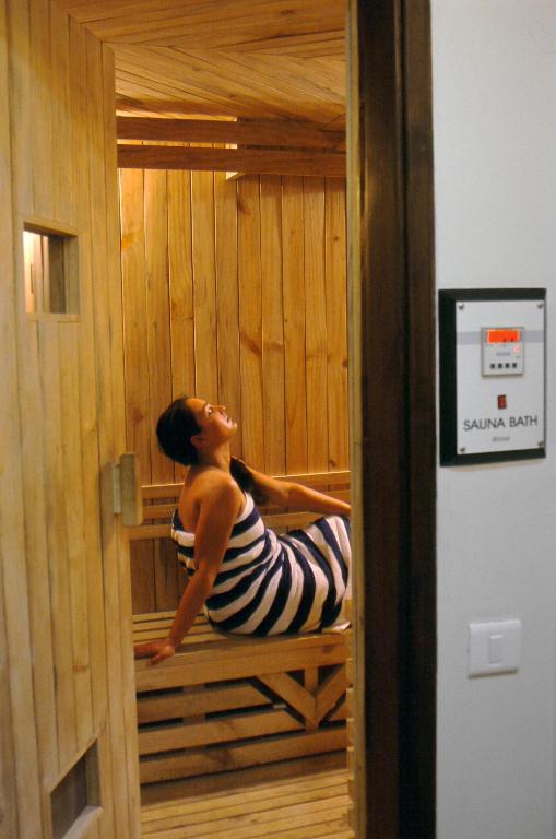 a woman is sitting in a sauna at Namah Nainital, a member of Radisson Individuals Retreats in Nainital