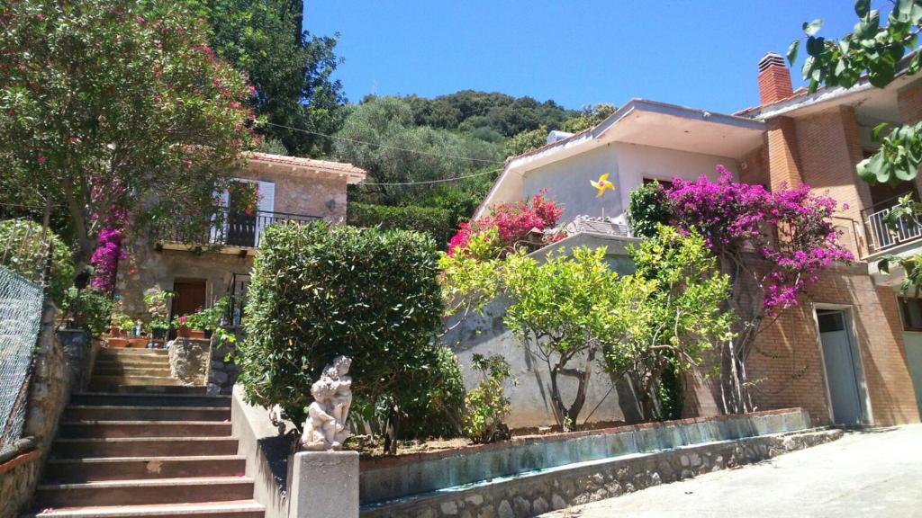 a house with stairs and flowers in front of it at Villa Lina B&B in San Felice Circeo