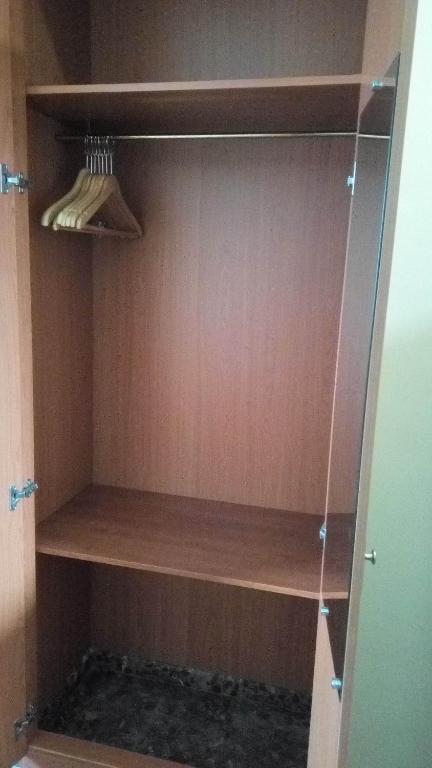 a cupboard with wooden shelves in a closet at Hotel Costa San Antonio in Cullera