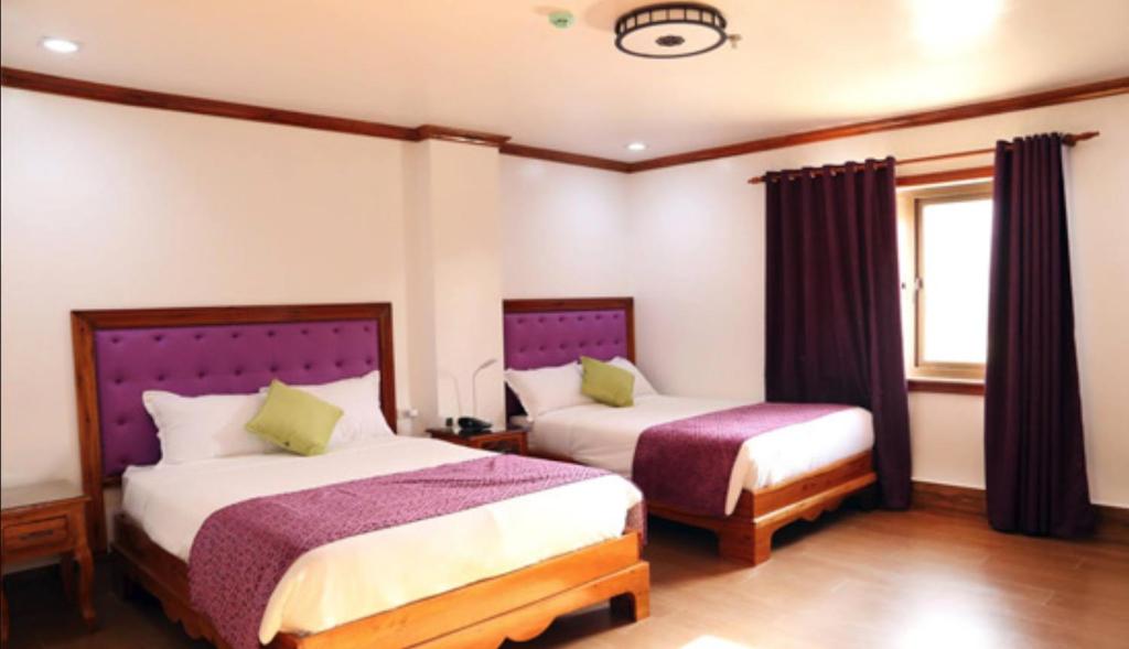 Postel nebo postele na pokoji v ubytování CLN Boutique Hotel